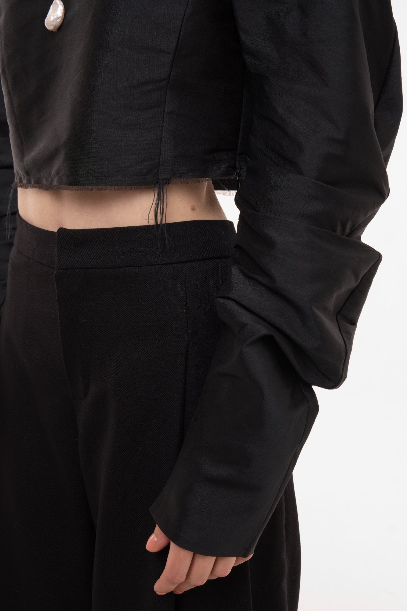 Detail of voluminous sleeve with gathered cuff and premium silk taffeta fabric