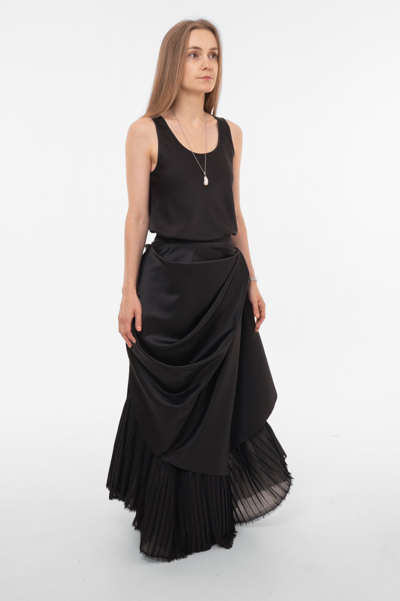 Front view of black asymmetric maxi skirt with draped overlay and fitted waistband - designer statement piece